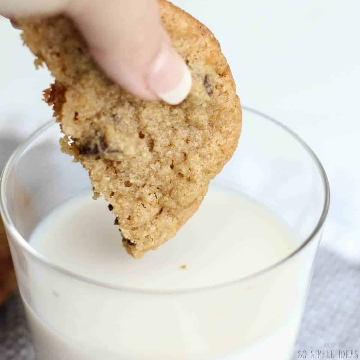 dipping cookie in glass of milk