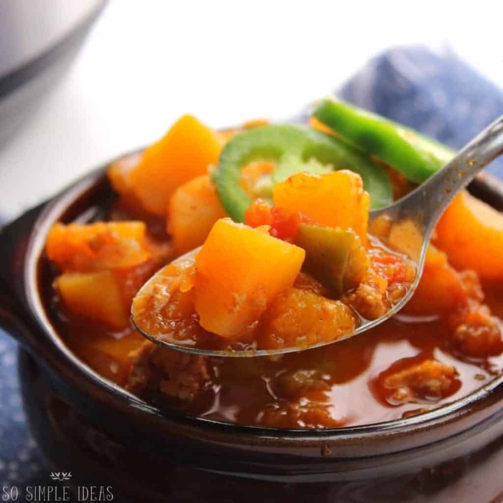 ground turkey chili on spoon over bowl