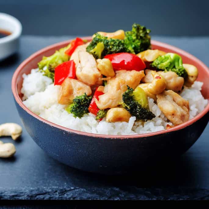 stir fry over rice in bowl