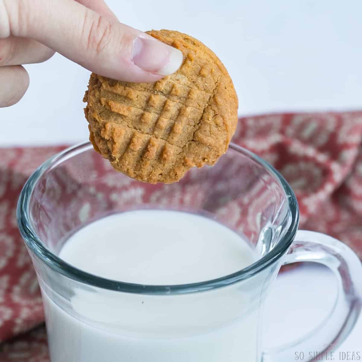 dipping cookie in milk