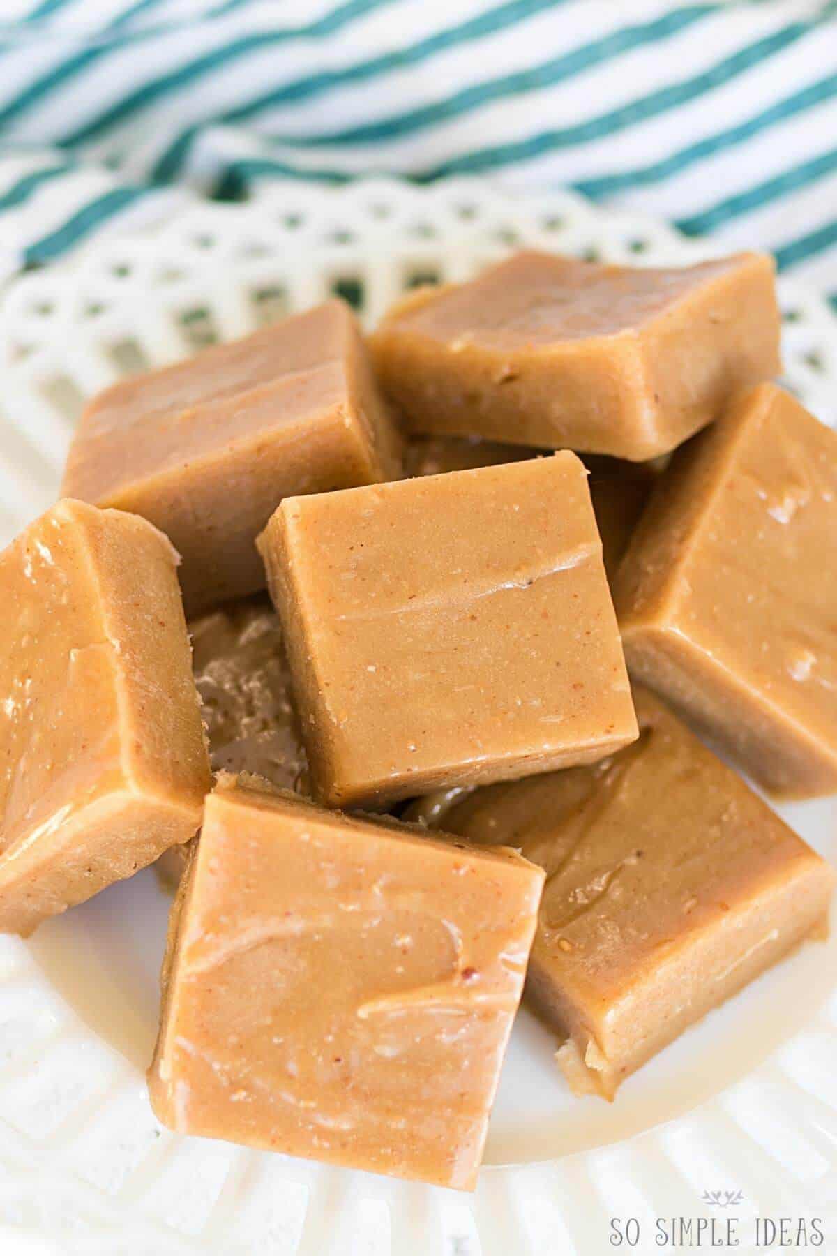 peanut butter fat bombs cut in squares on white plate