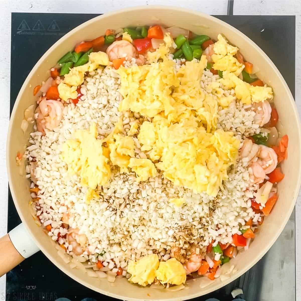 adding cauliflower rice seasoning and egg.