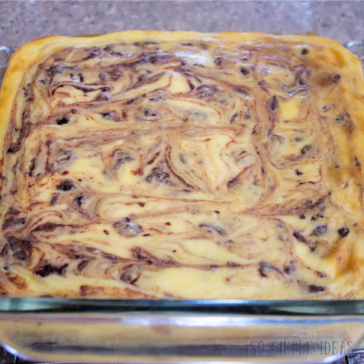 baked cheesecake swirl brownies in pan.