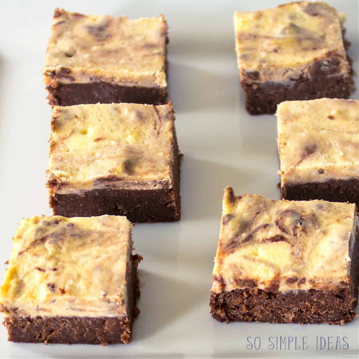 cheesecake brownies on white plate.