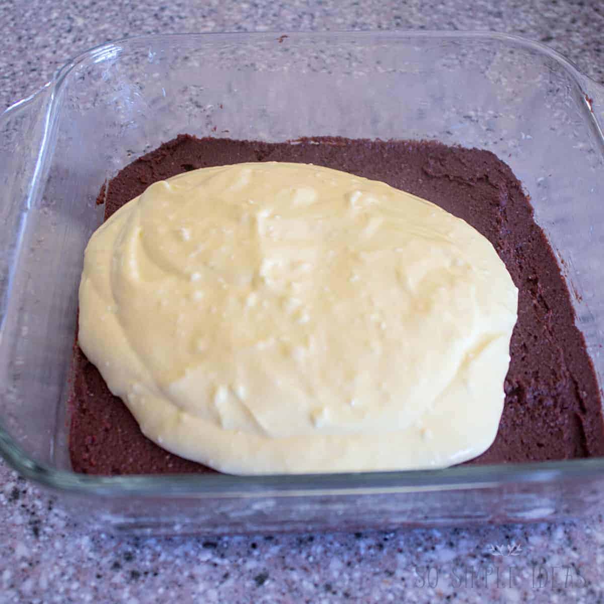 adding cheesecake layer over brownie layer.