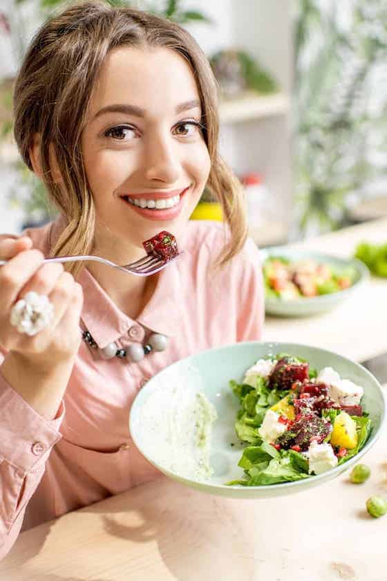 woman eating a salad.