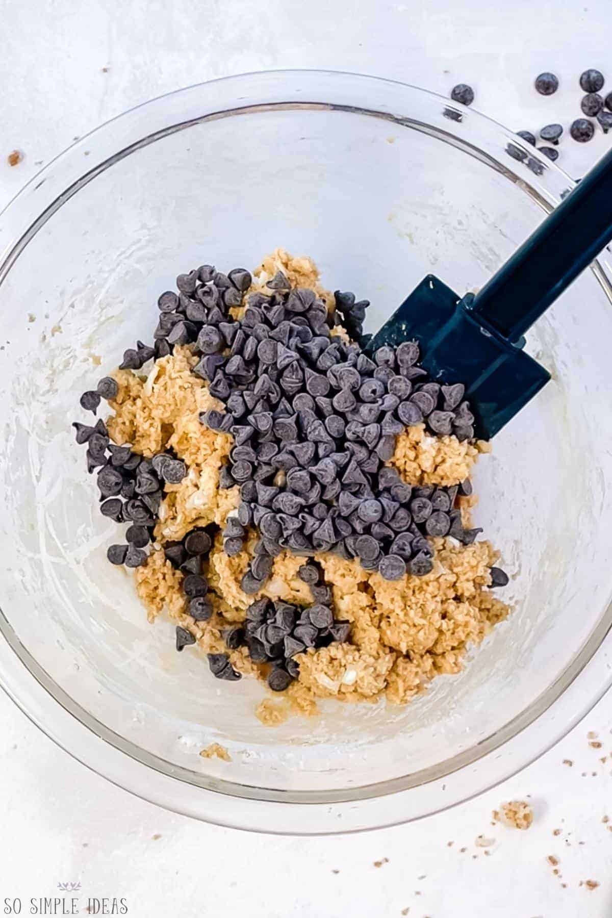 adding baking chips to cookie dough.