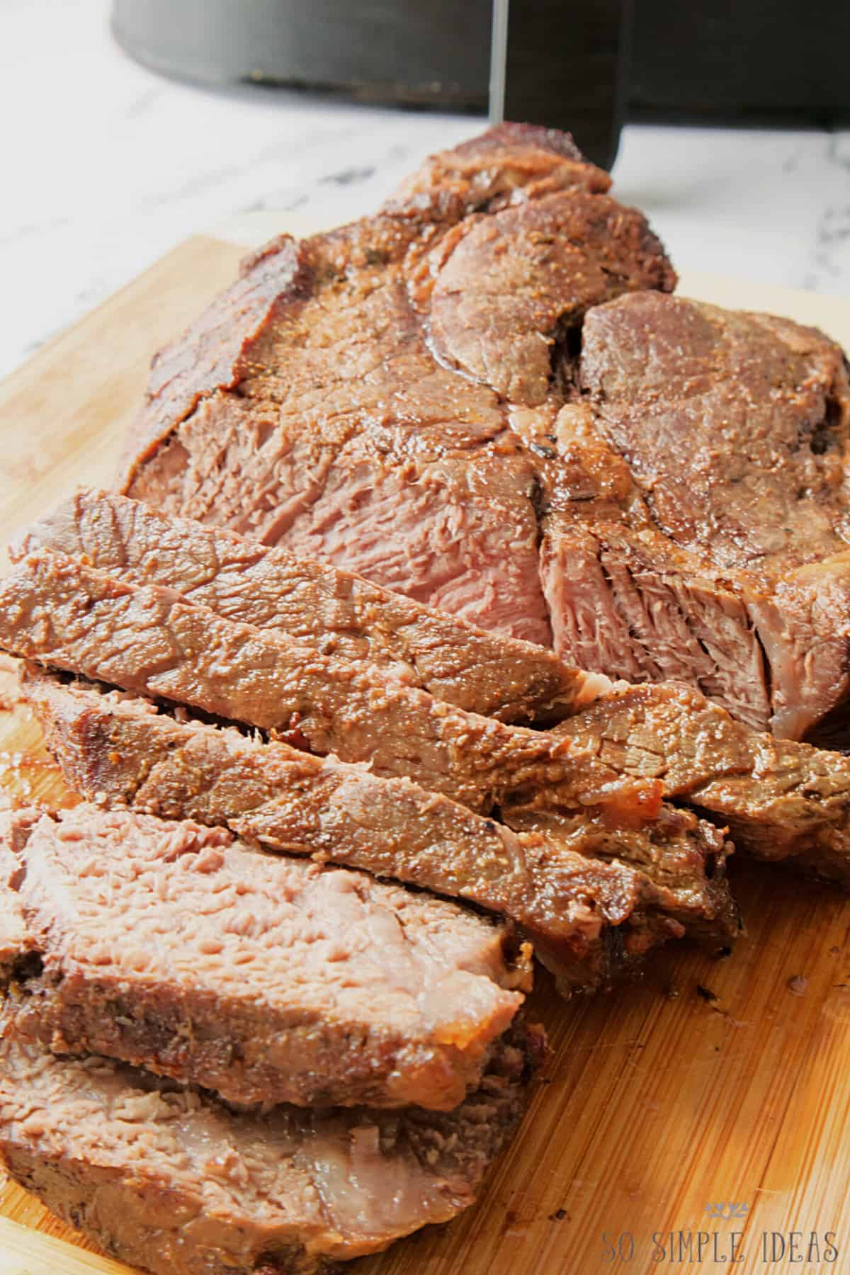 air fryer roast beef sliced on board.