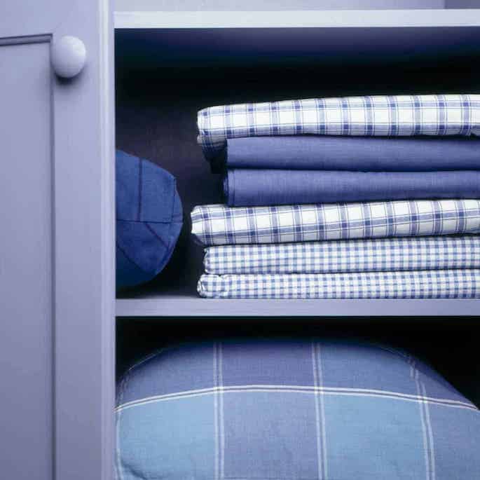 linen storage in blue cabinet.