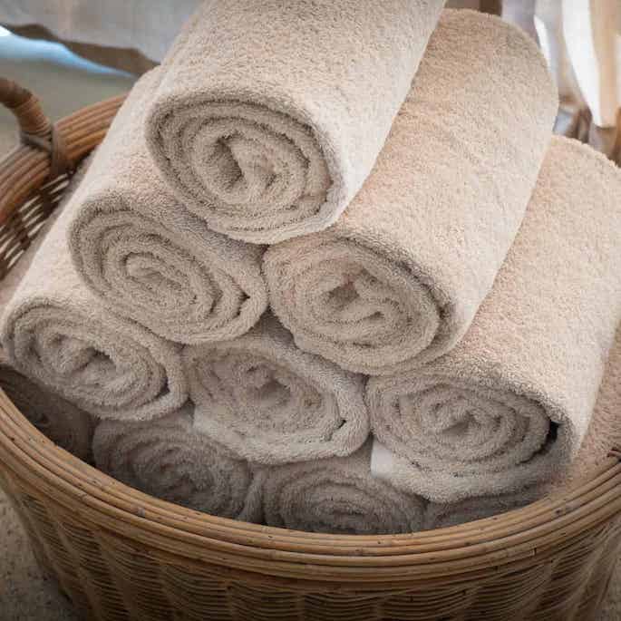 towels rolled and stored in a basket.