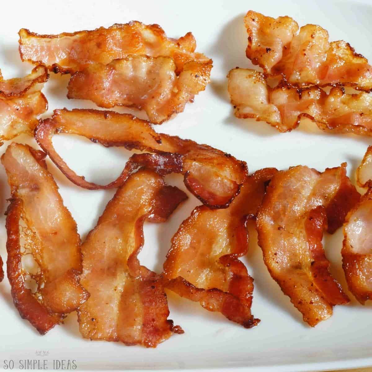 cooked bacon on white plate.