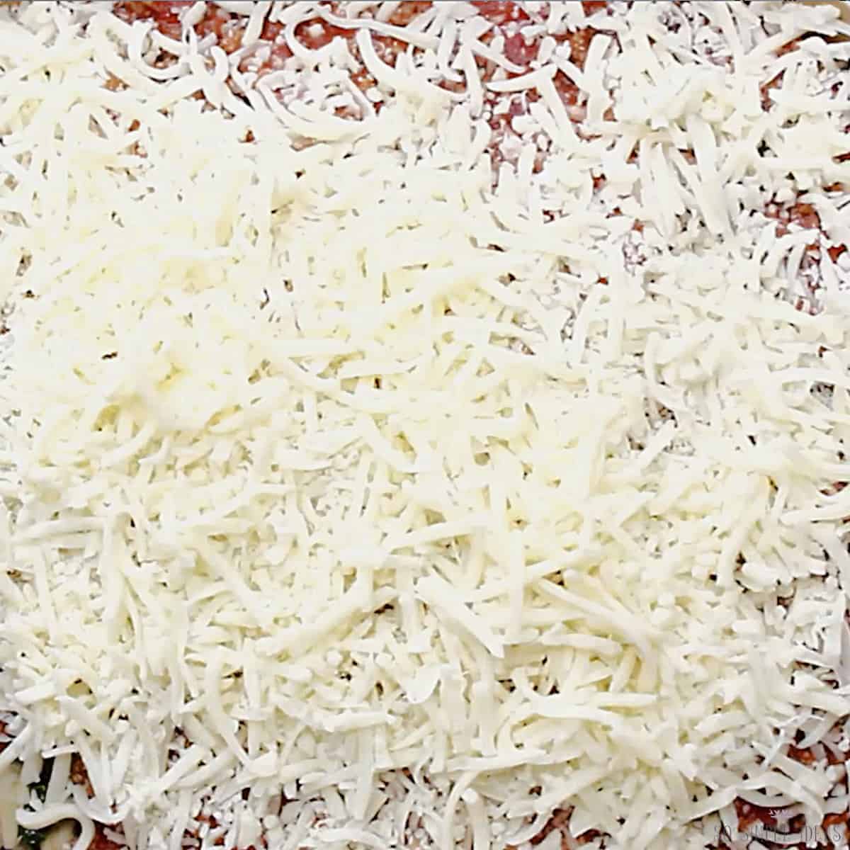 mozzarella topping added to lasagna.