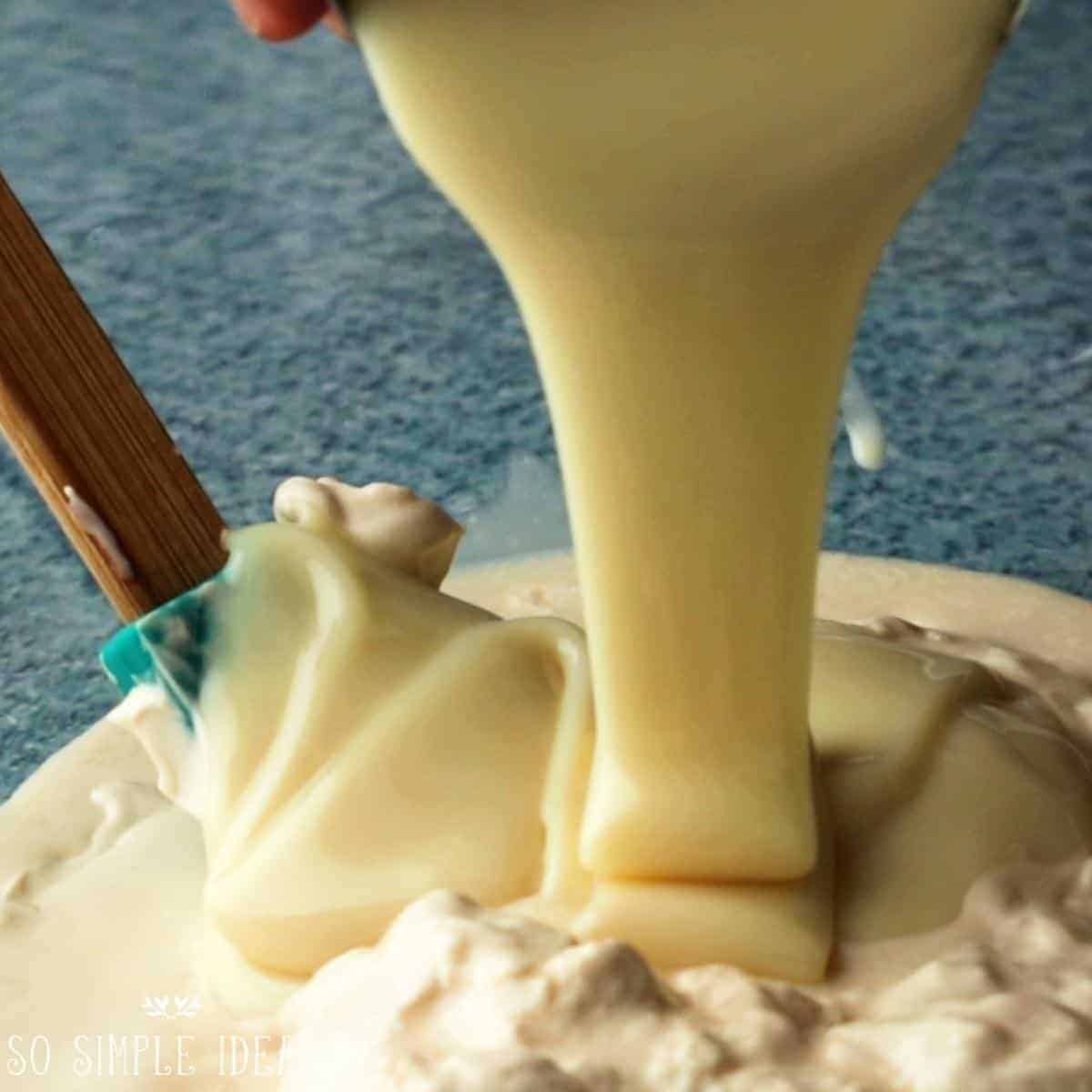 adding condensed milk to table cream.