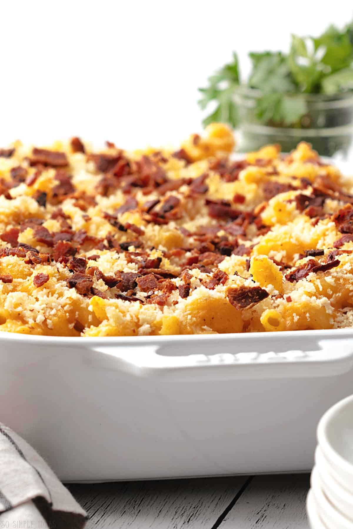 baked steakhouse mac and cheese in white casserole pan.