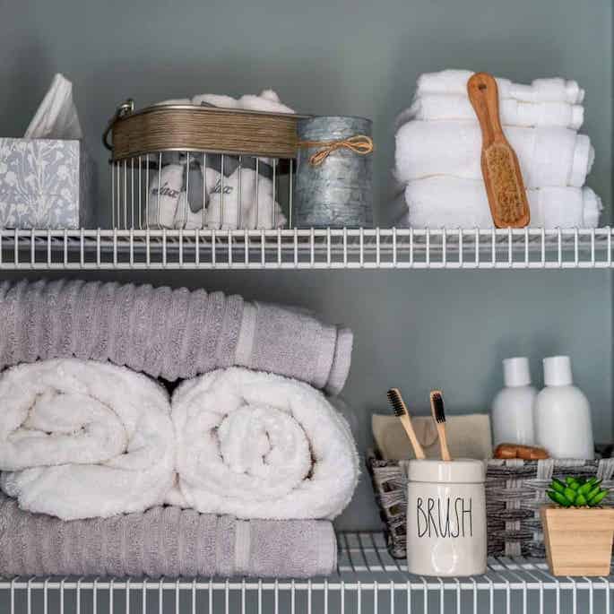 bathroom closet with wire shelving organized.