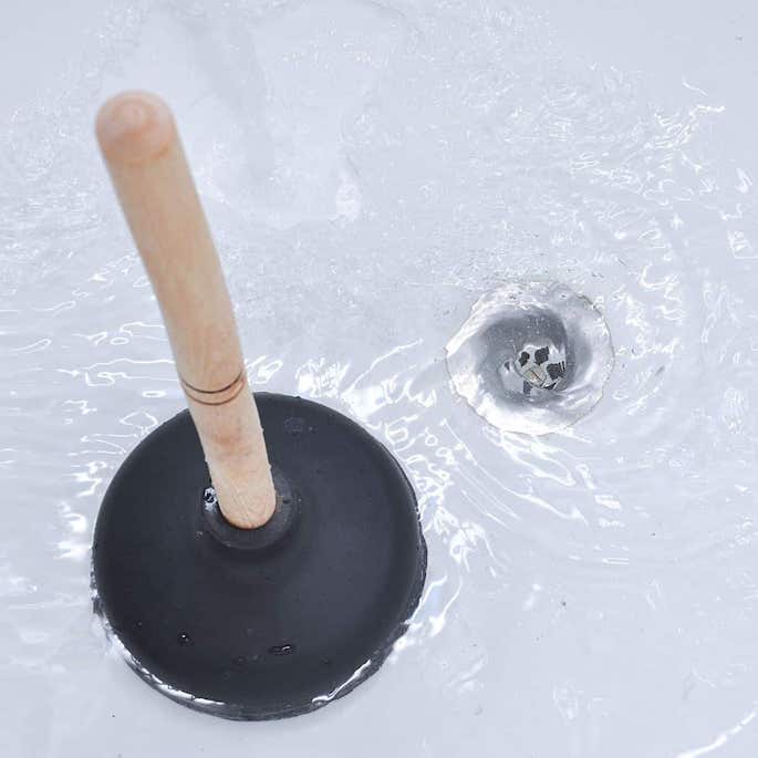plunger used to clear drain of hair.