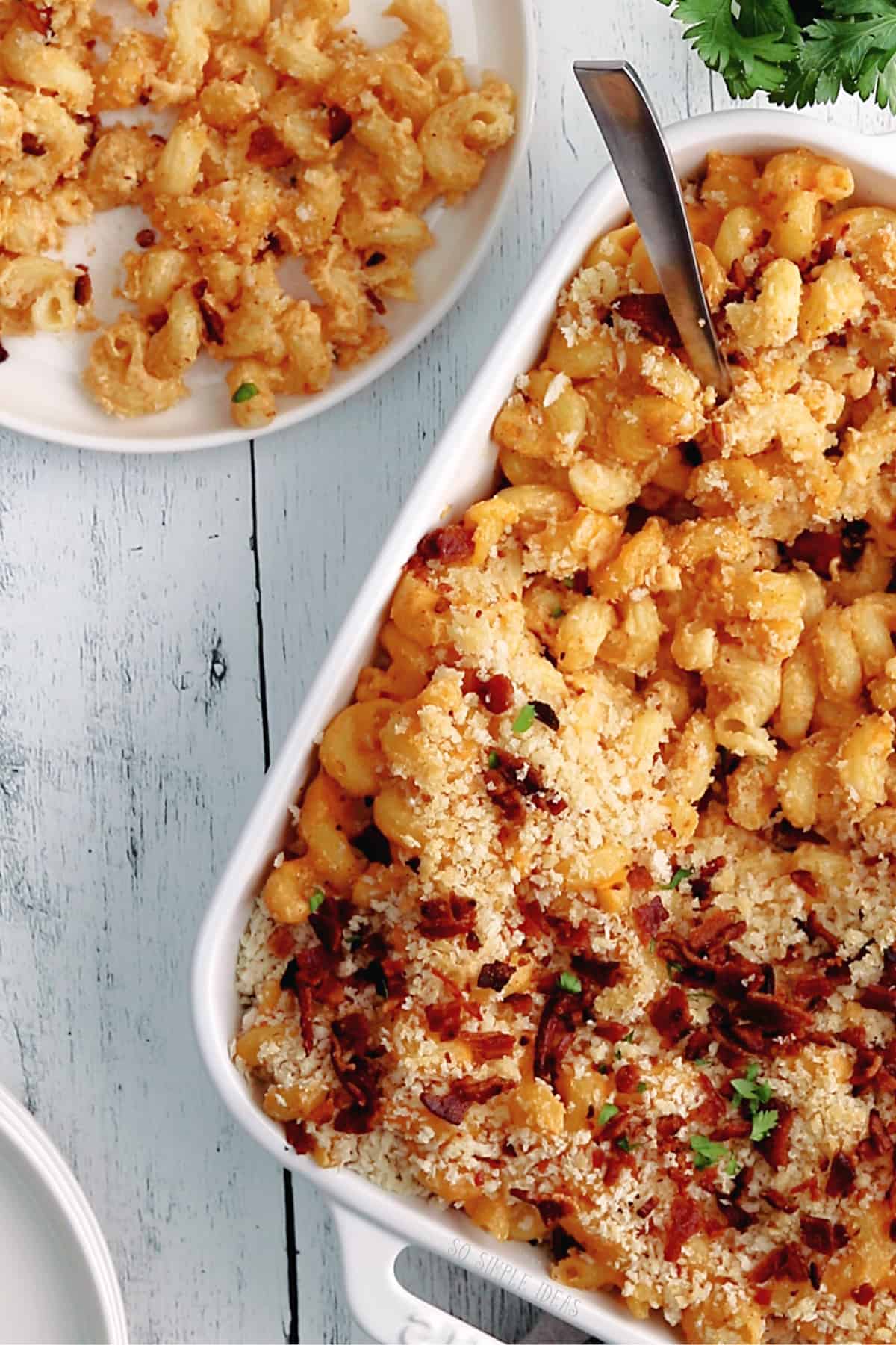 steakhouse mac and cheese in casserole pan and white plate.