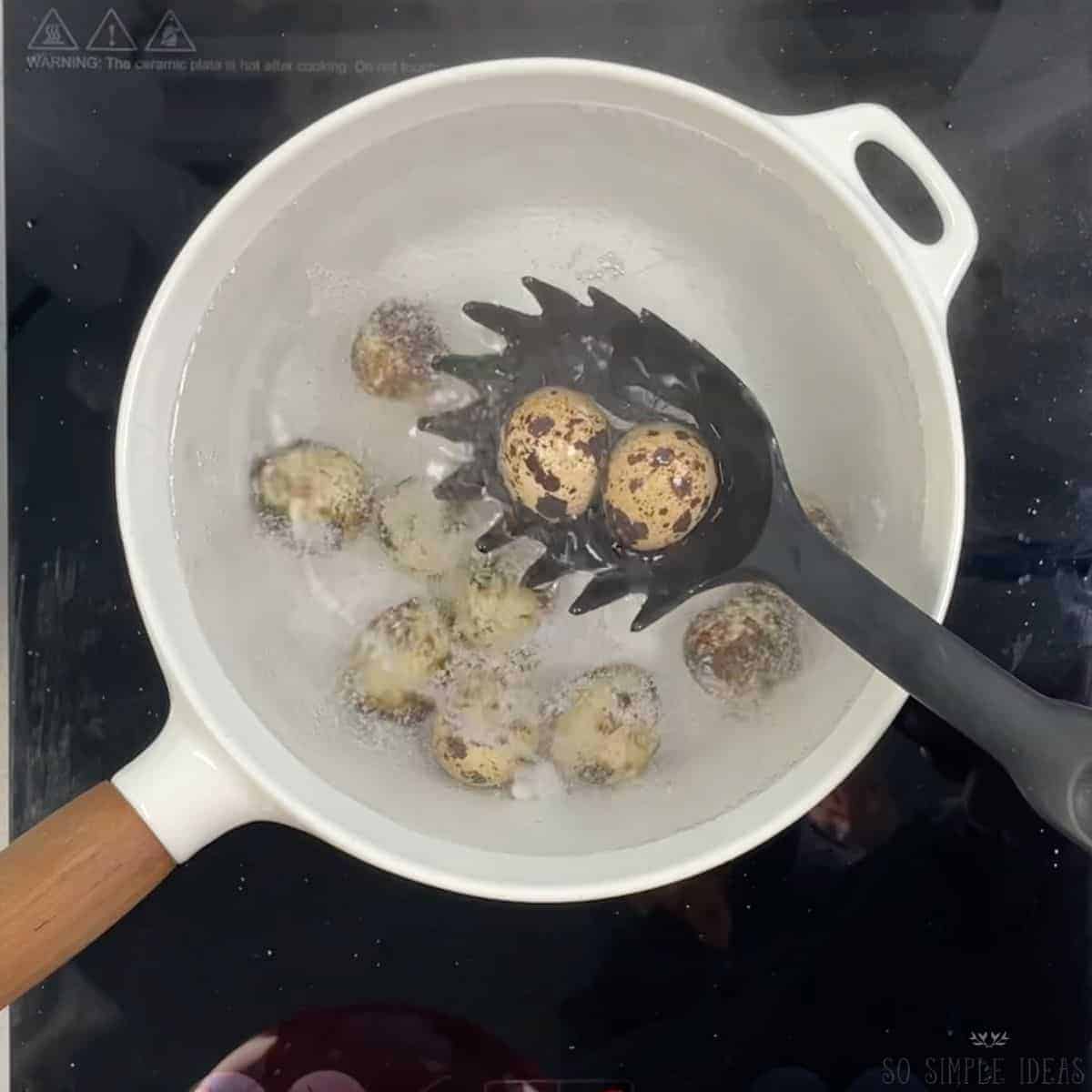 adding quail eggs to boiling water.