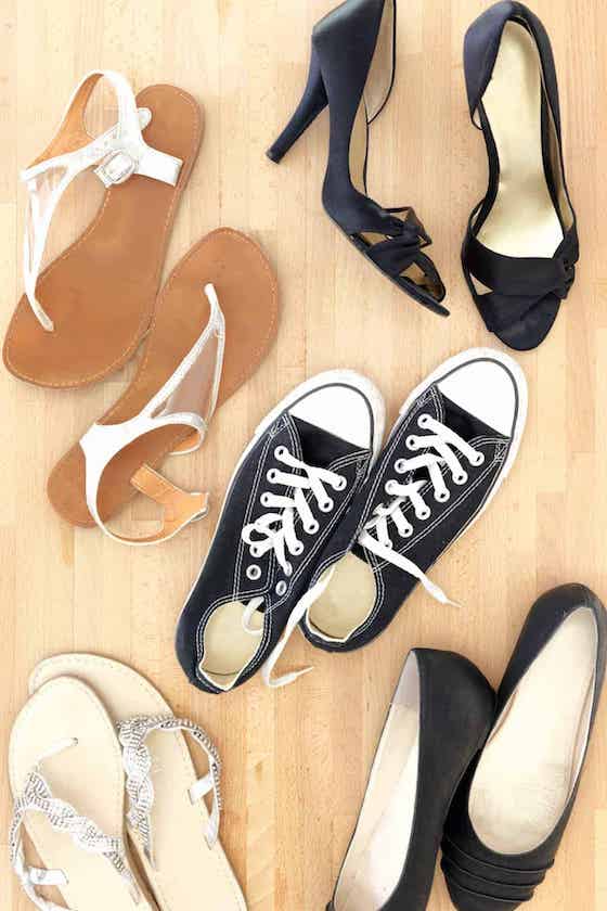 different pairs of shoes on floor.