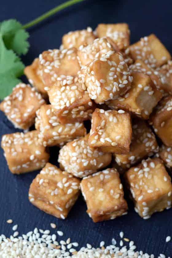 cooked tofu with sesame seed garnish.