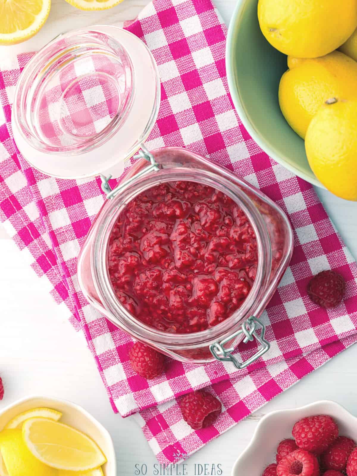 overhead view of raspberry compote in jar.