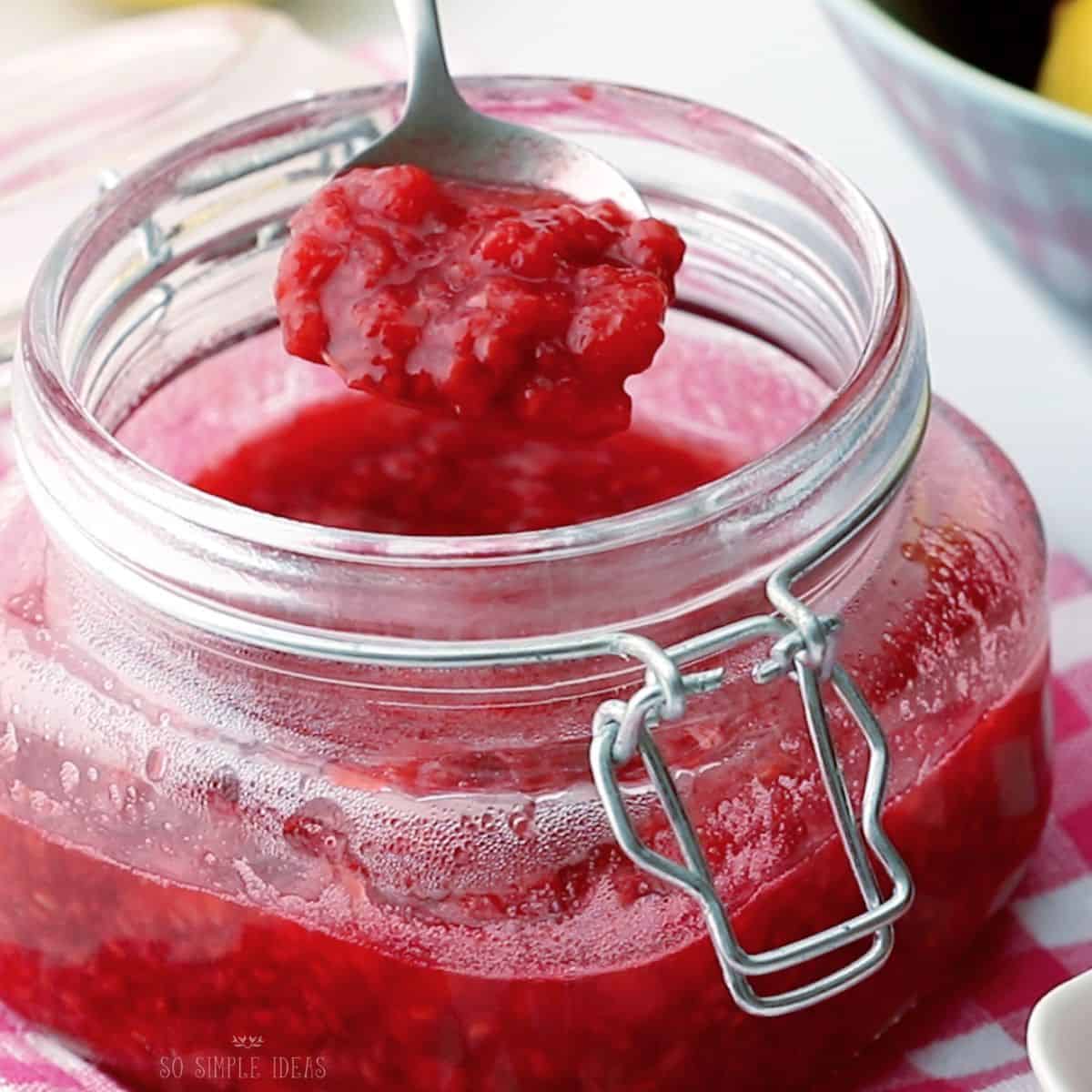 raspberry compote in spoon.