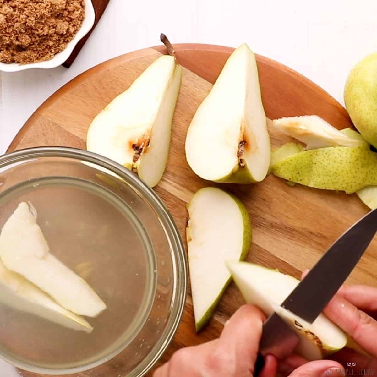 adding sliced pears to lemon bath.