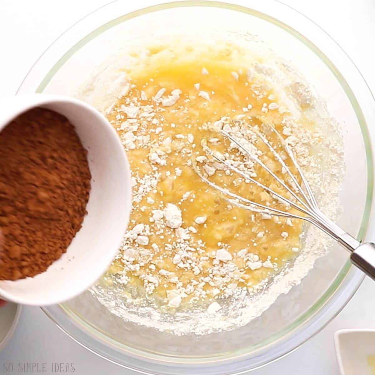 adding brownie dry ingredients to batter.