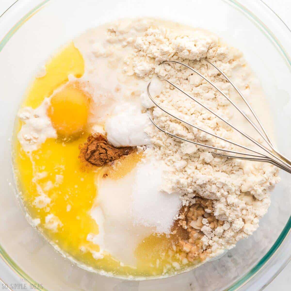 ingredients in glass mixing bowl with whisk.