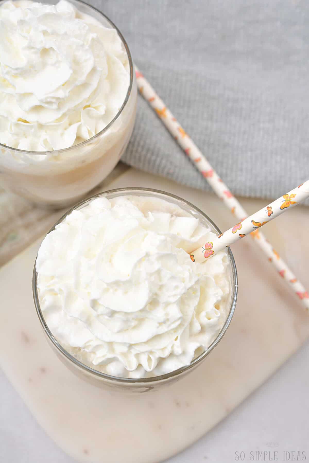 overhead view of two white chocolate mochas in glasses.