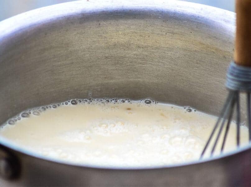 simmering coconut milk in pot.