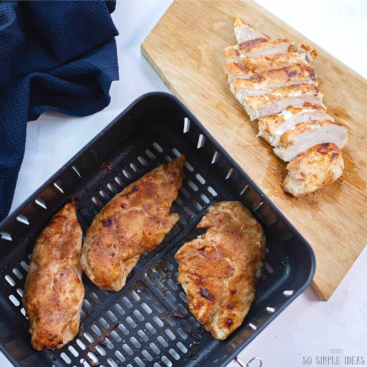 slicing bbq chicken from air fryer basket.